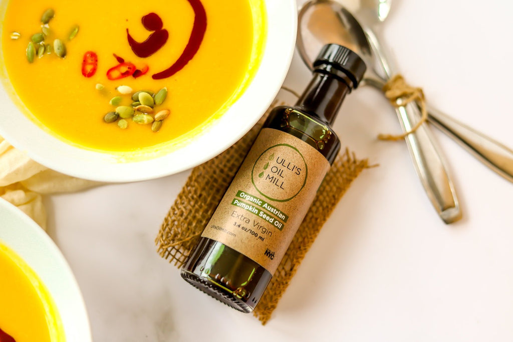 Bowl of pumpkin squash soup drizzled with pumpkin seed oil